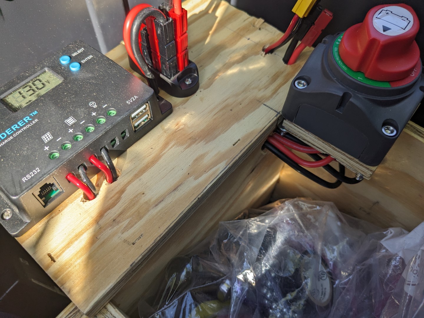 A close up of the wiring into the battery compartment, and out to the solar controller, switch, and Power Poles.